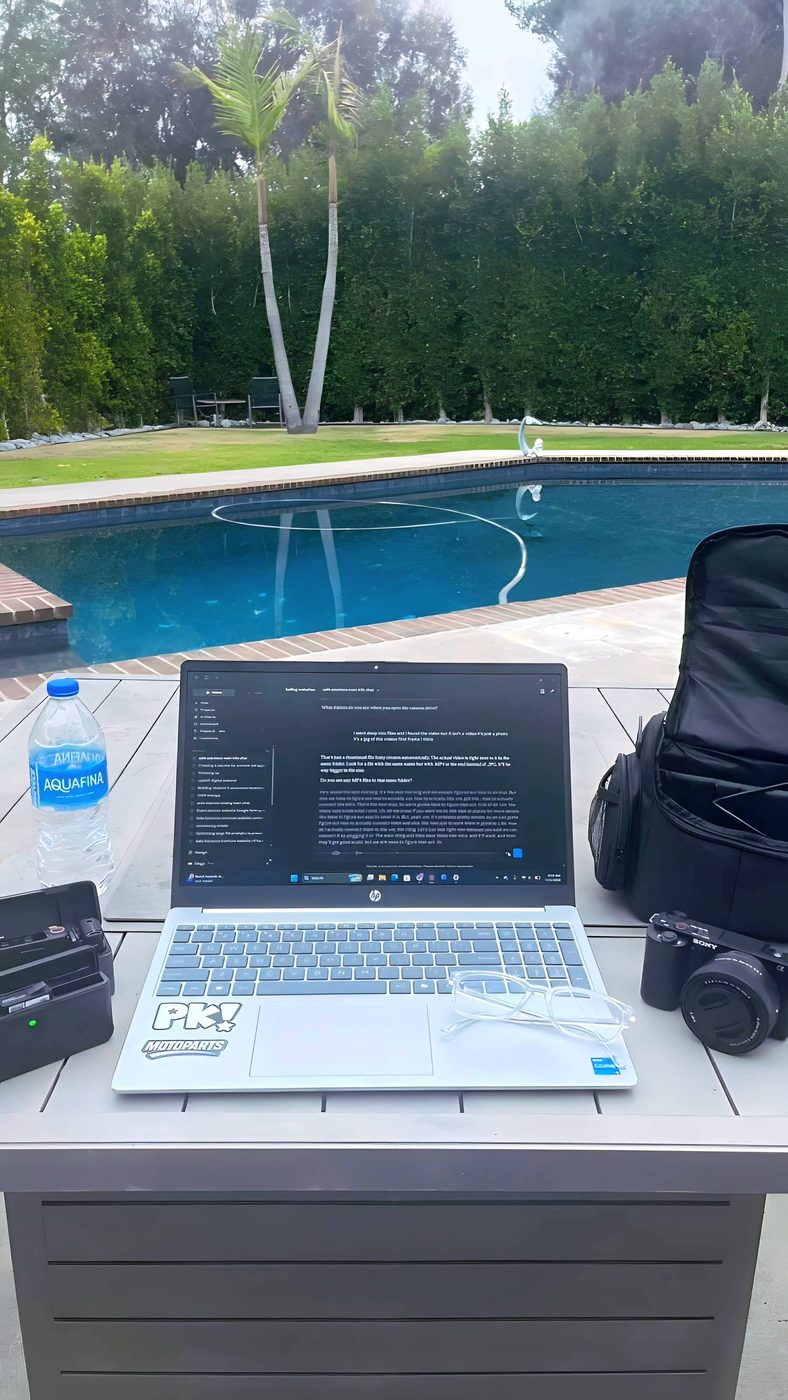 Remote work setup in San Diego with laptop and Sony camera gear during the production trip